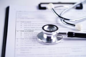 Health insurance accident claim form with stethoscope, Medical concept.