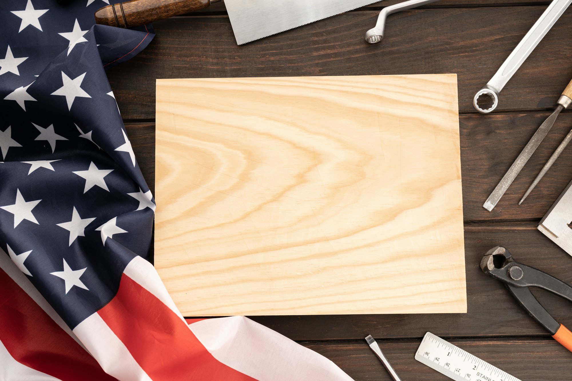 Top view of american flag , work tools and blank wooden plank for text
