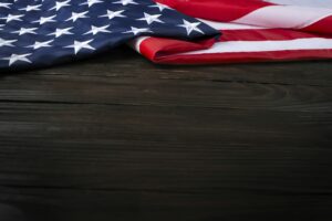 US flag on wooden background with copyspace